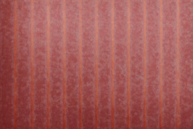 A red striped wallpaper with a pattern of flowers.