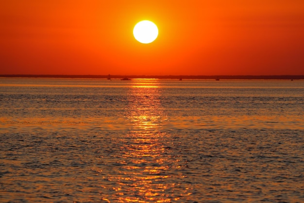 Red sunset over the bay with silhouettes