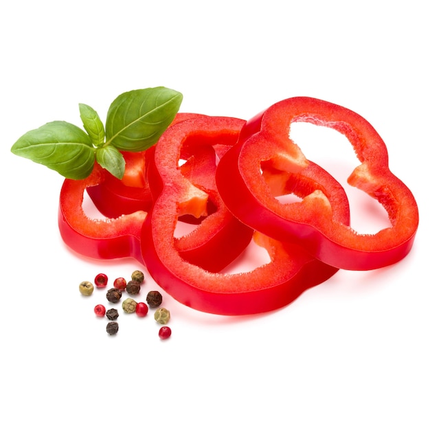 Red sweet bell pepper slices and basil leaves isolated on white background cutout