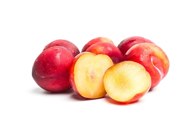 Red sweet plums on a white background