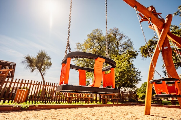 Red swing in green garden Child relax concept