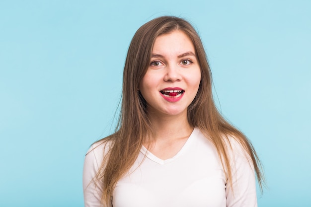 Red tablet in the mouth of the woman  