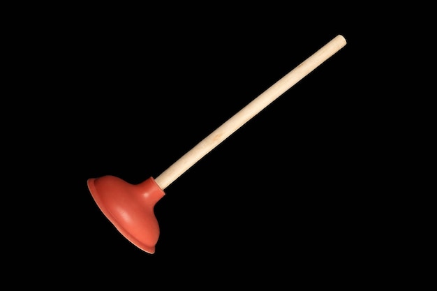 Red toilet plunger Isolate on black background Plumbers drain cleaner tool Equipment for clearing blockages