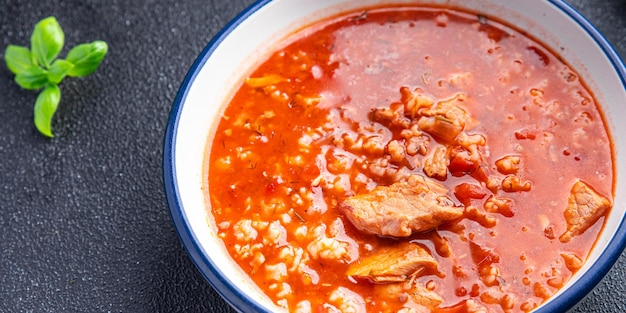 red tomato soup kharcho meat, rice cooking healthy meal food snack diet on the table copy space