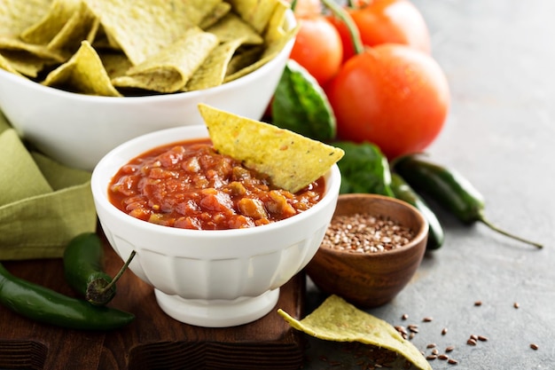 Red tomato spicy salsa with chips