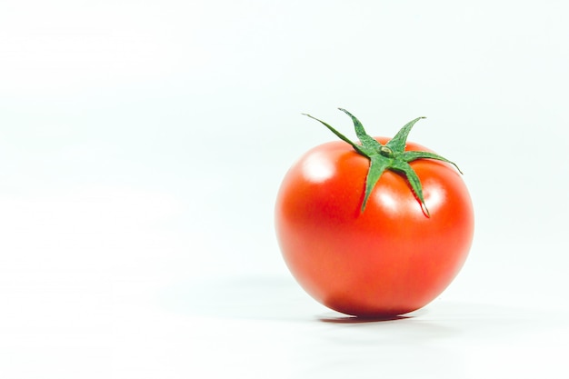 Red tomatoes on  White