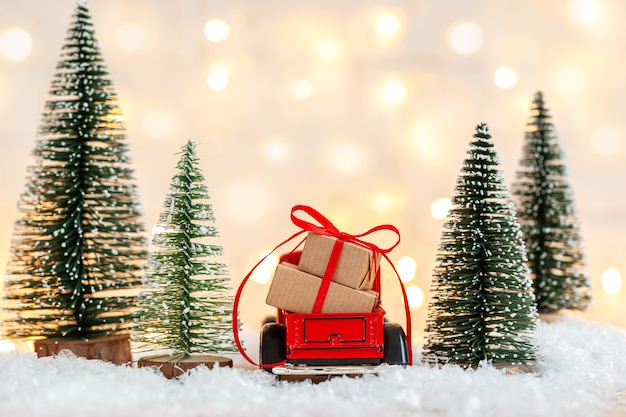 Red toy car with Stack of Christmas gift boxes