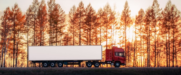 Red truck on a road at sunset. Focus on container