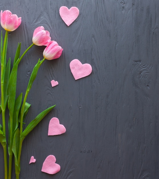 Red tulips on grey background