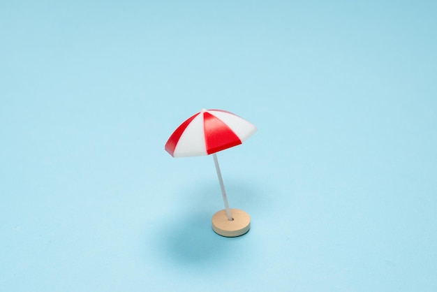 Red umbrella on a blue background. Copy space.