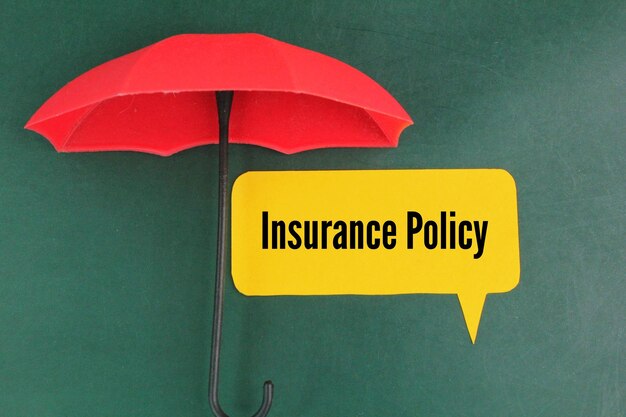 Photo red umbrella and colored paper with the word insurance policy