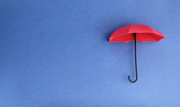 red umbrella with blue background insurance coverage concept