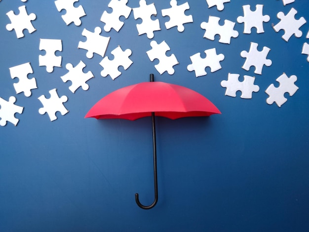 Red umbrella with white puzzle