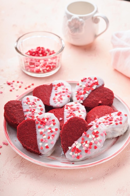 Red velvet or brownie cookies on heart shaped in chocolate icing on a pink romantic background Dessert idea for Valentines Day Mothers or Womens Day Tasty homemade dessert Cake for Valentines Day