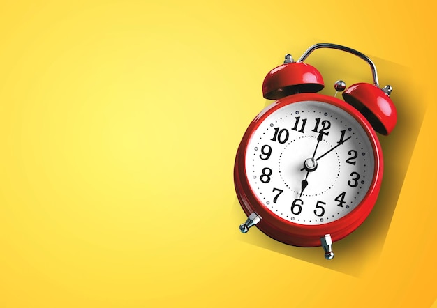 Red vintage alarm clock on yellow background. Alarm clock with place for text.