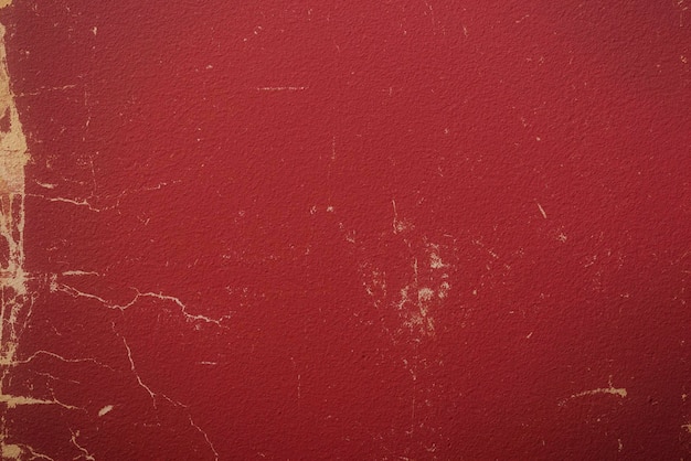 A red wall with a white spot on it that is covered with paint and has a white spot on it.