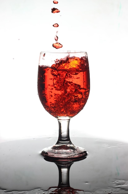 red water splash in wine glass