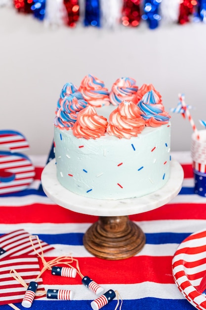 Red, white, and blue round vanilla cake with buttercream frosting for July 4th celebration.