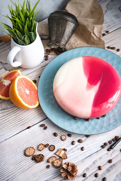 Red and white cake with orange filling. Nearby on a black table are ingredients oranges, nuts. Rustic style.