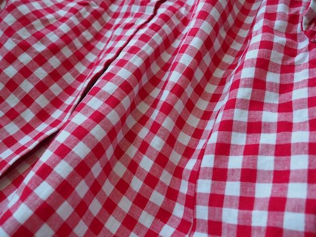 Red and white checkered background with striped squares for picnic blanket tablecloth plaid shirt and textile Fabric texture Cotton fabric in red and white square crumpled and folded in waves