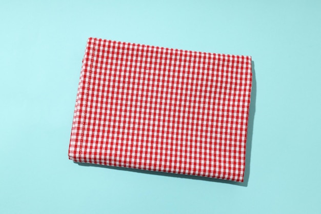 Red and white checkered tablecloth on blue background