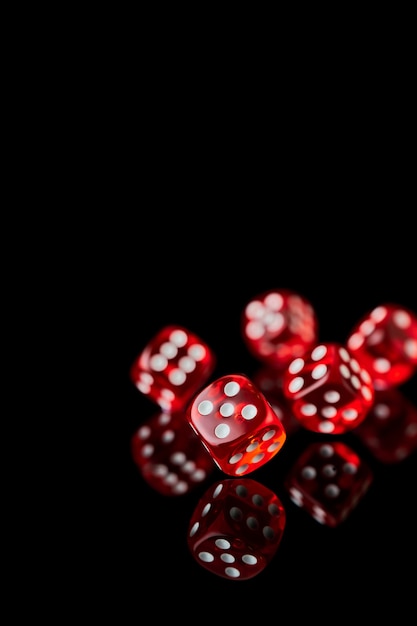 Red and white craps or dices on reflective black background