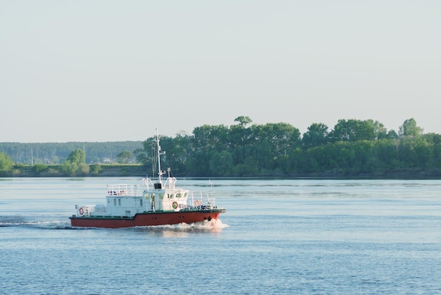 Red and white fishing trawler or boat afloat