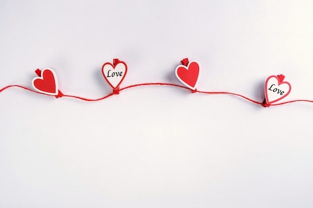 Red and white hearts hanging on rope. Valentine's Day concept.