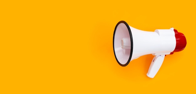 Red and white megaphone on orange background.