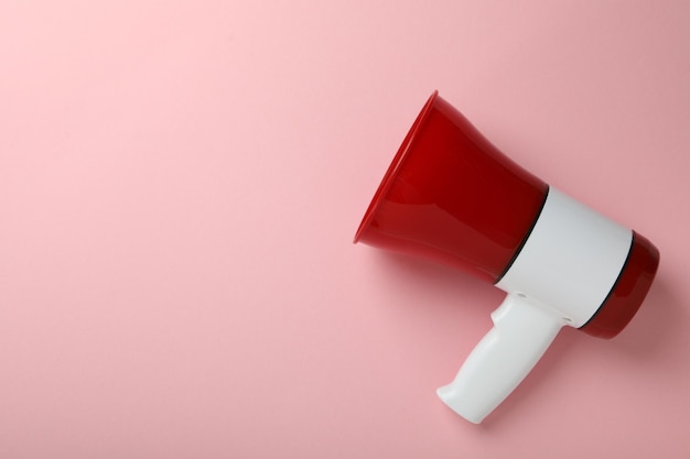 Red and white megaphone on pink background