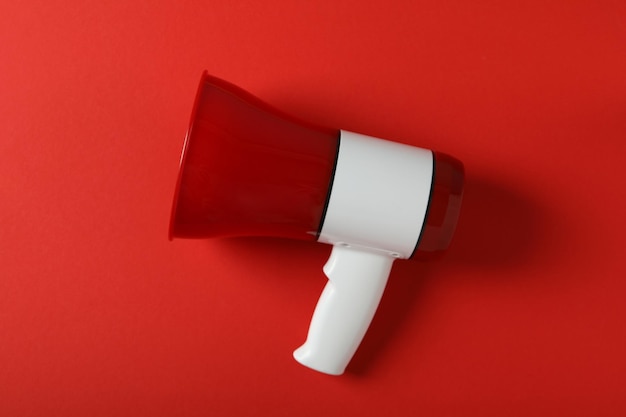 Red and white megaphone on red background