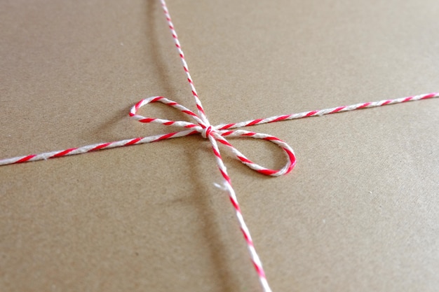 Red and white parcel rope close up package