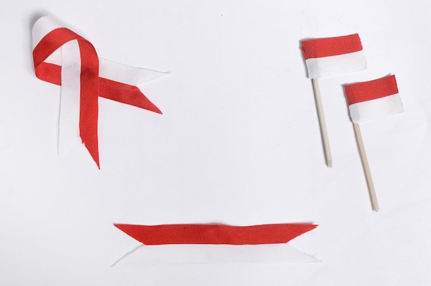 Red and white ribbon and flag with empty space on a white background the concept of celebrating Indonesian independence and Indonesian national day