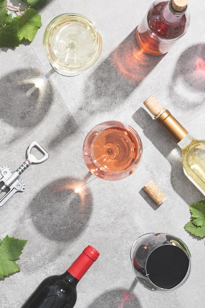 Red white and rose wine in wine glasses on concrete background Top view Beverage and wine concept