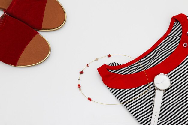 A red and white striped shirt with a pair of shoes and a pair of leather shoes.