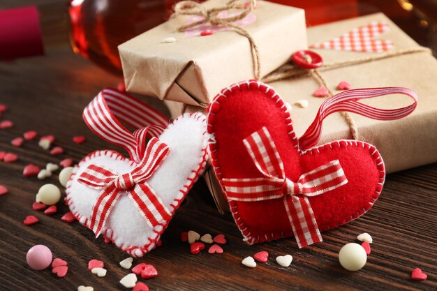 Red wine bottle and gift box on wooden background