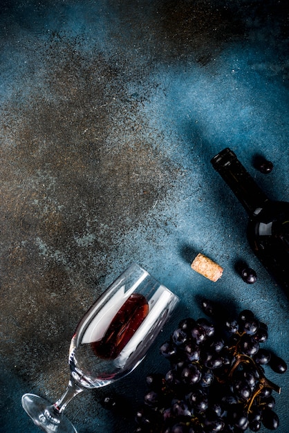 Red wine bottle with glass and grapes