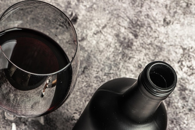 Red wine glass and bottle top view