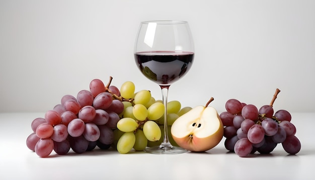 red wine in a glass served with fresh fruits grapes pears on white background