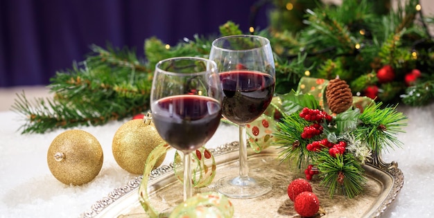 Red wine glasses on snow