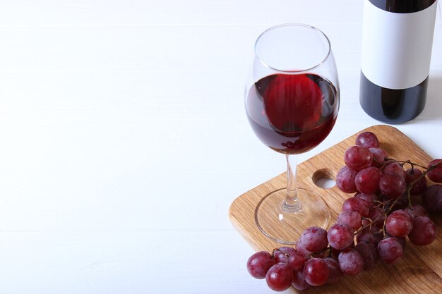 Red wine and grapes on the table top view