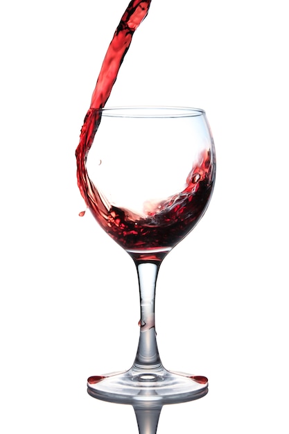 Red wine pouring into glass isolated