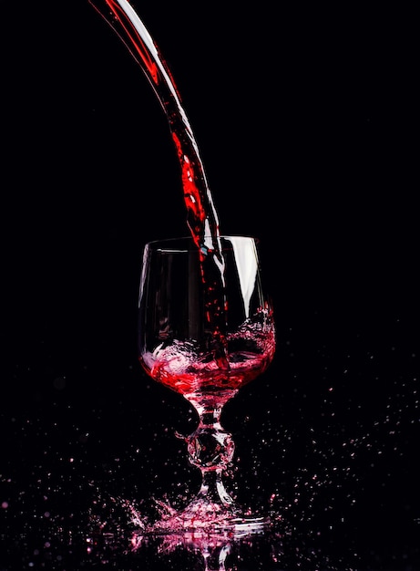 Red wine pouring into wine glass