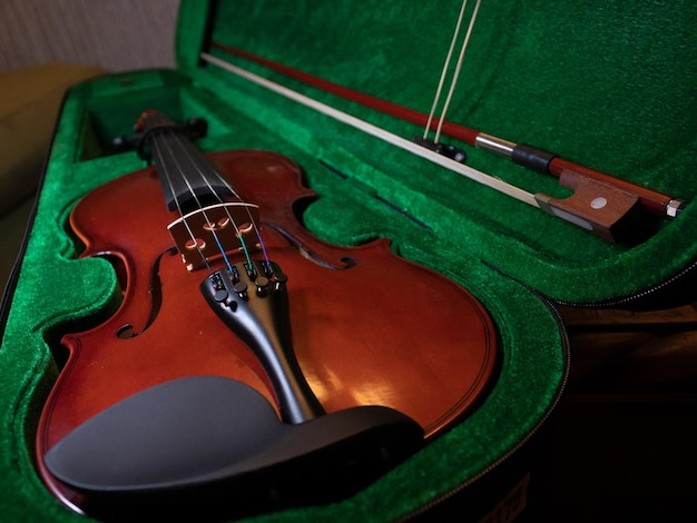 Red wooden violin in box