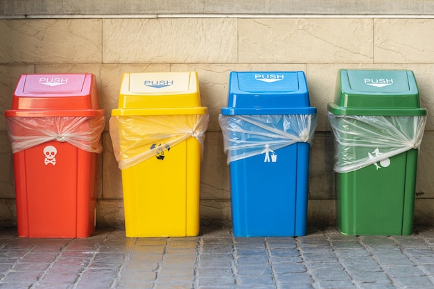 Red yellow blue and green plastic trash on the floor in front the supermarket