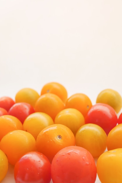 Red and yellow color cherry tomato isolated on white