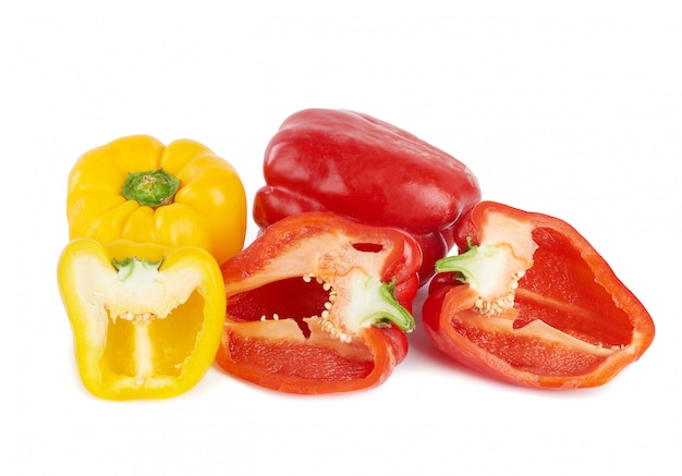 Red and yellow sweet peppers on white