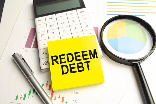 REDEEM DEBT text on the yellow card on the chart background