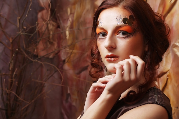 Redhair woman with bright creative make up