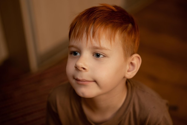 Redhaired young boy in thought attention